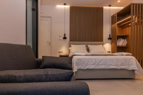 a bedroom with a bed and a couch at Irene Studios in Mastichari