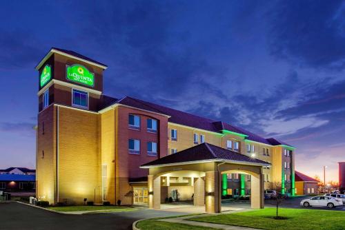 a hotel with a clock tower on top of it at La Quinta by Wyndham Indianapolis Airport Plainfield in Plainfield