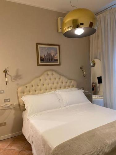 a bedroom with a large bed with a white bedspread at Duomo Prestige in Milan