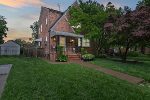 a brick house with a gate and a yard at Stately 5BR Historic Retreat - CozySuites in Alexandria