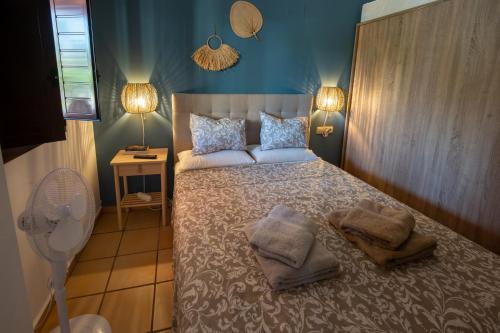 a bedroom with a bed with pillows and a fan at Casa Cariño @ Hacienda del Alamo Golf resort in Fuente Alamo