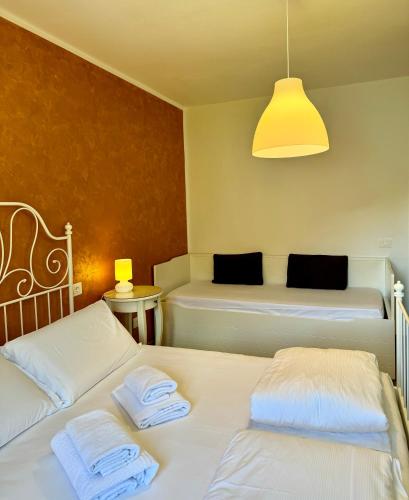 a room with two beds and a light fixture at Serena Charme View in Mezzolago