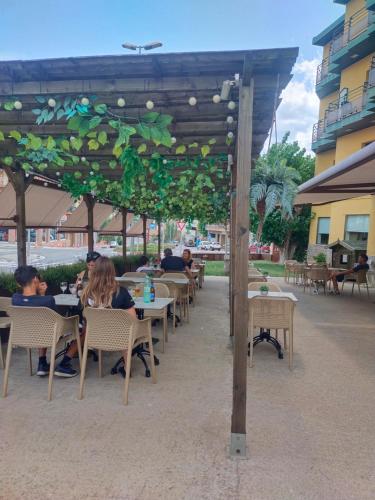 a group of people sitting at tables under a canopy at Hostal Buenos Aires in Tremp