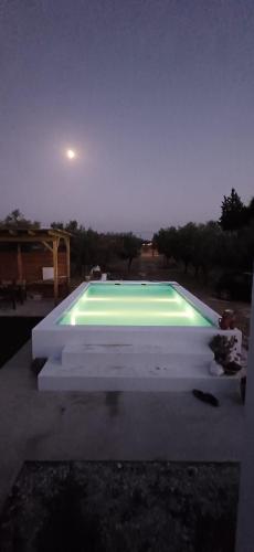 a swimming pool at night with the moon in the sky at Cor de Azeitona in Aldeia do Mato