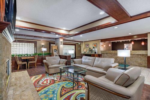 a large living room with couches and a table at Quality Suites Addison-Dallas in Addison