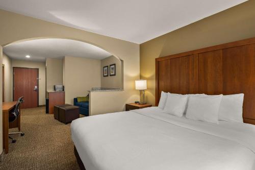 a hotel room with a large bed and a desk at Comfort Inn Ogden near Event Center in Ogden
