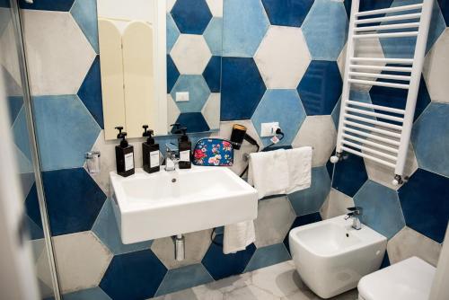 a blue and white bathroom with a sink and a toilet at River Song - Vietri sul Mare in Vietri sul Mare