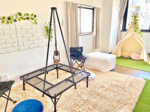 a living room with a swing in the middle at THE MOON Atami in Atami