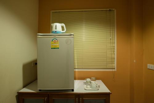 a white refrigerator in a room with a window at Lareena Resort Koh Larn Pattaya in Ko Larn