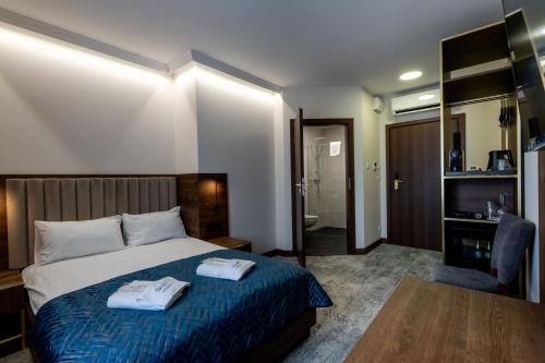 a hotel room with a bed with two towels on it at Sleep&Fly Okęcie Warsaw Airport in Warsaw