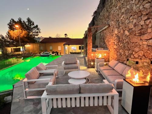 une terrasse avec des canapés et une piscine dans l'établissement Villa 4 chambres à Cap D'Ail près de Monaco, à Cap d'Ail