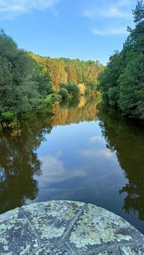 a view of a river with trees in the background at Sunny terrace in Střížov