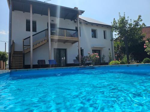 a house with a swimming pool in front of a house at Studio apartmen in Budapest