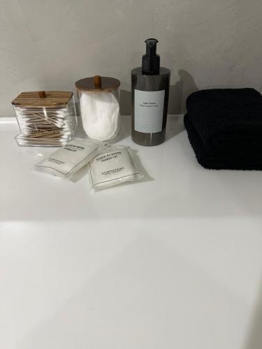 a white table with a bottle of soap and a candle at ILION Villa in Athens