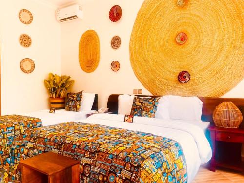 a room with two beds and plates on the wall at Kerama Silent Lodge in Arusha
