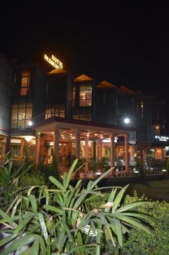 a building at night with plants in front of it at Hotel Padmini Palace in Rāni Pokhri