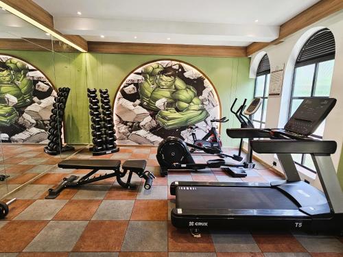 a fitness room with a hulk mural on the wall at Bhanu The Fern Forest Resort & Spa, Jambughoda in Jambughoda