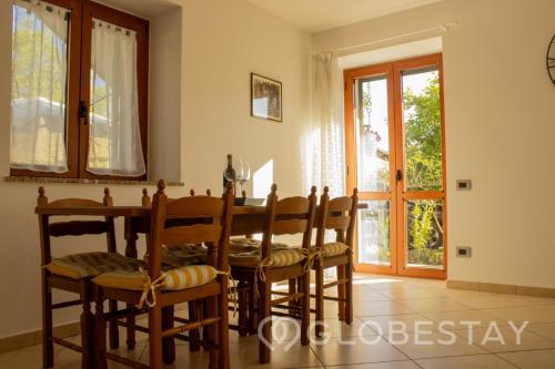 a dining room with a table and a window at Villa SalMar Apartment 1 BBQ and Garden in Gavirate