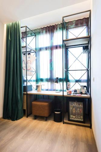 a room with a desk in front of a window at Axel Hotel Bilbao - Adults Only in Bilbao