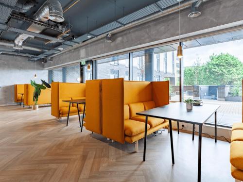 an office with yellow chairs and tables and windows at For Students Only - Ty Nant in Swansea in Swansea