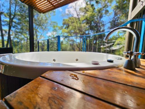 a bath tub sitting on top of a wooden table at Villa 521 Kingfisher Bay Fraser Island in Kingfisher Bay