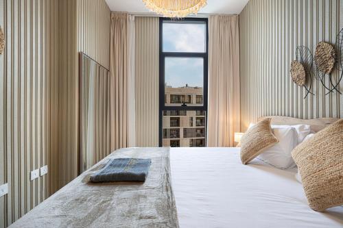 a bedroom with a large bed with a window at 1BR Private Poolview Apartment - Poolside Paradise in Sharjah