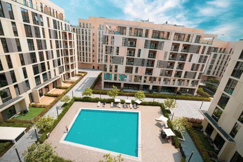 an overhead view of a large apartment complex with a swimming pool at 1BR Private Poolview Apartment - Poolside Paradise in Sharjah