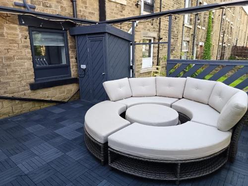 a white couch sitting on top of a balcony at The Happy House in Huddersfield