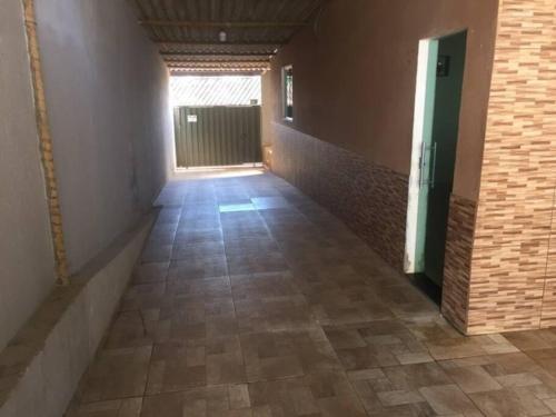 a hallway with a tile floor in a building at Casa com piscina em Esmeraldas MG in Esmeraldas