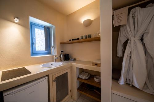 a bathroom with a sink and a window at Luna Santorini Suites in Pirgos