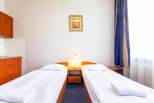 a hospital room with two beds and a desk at Noclegi Stadion Bed & Breakfast in Warsaw