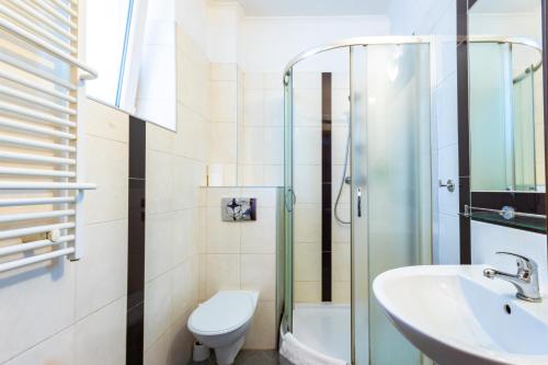 a bathroom with a toilet sink and a shower at Noclegi Stadion Bed & Breakfast in Warsaw