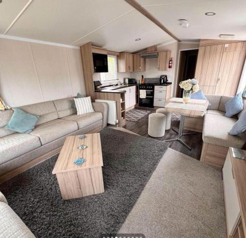 a living room with a couch and a table at Rockley Park Poole caravan-3Bed-On site Activities in Poole