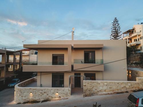 a large white building with a balcony at Dreta Suites in Chania Town