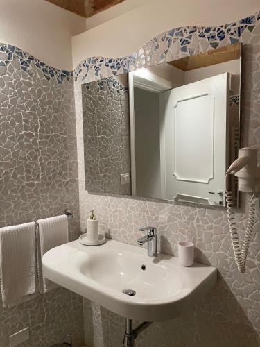 a bathroom with a sink and a mirror at Barbarossa Sea Room in Termoli