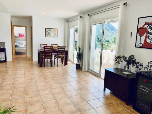 a living room with a dining room and a table and chairs at Hauzify I Casa Gaditana in Santa Cristina d'Aro