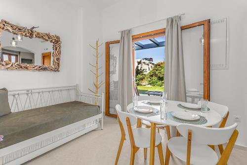 a bedroom with a table and chairs and a bed at Anemonisia Skyrian Living in Skiros
