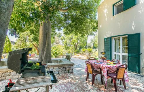 a patio with a table and chairs and a bench at 4 Bedroom Nice Home In Ragusa in Ragusa