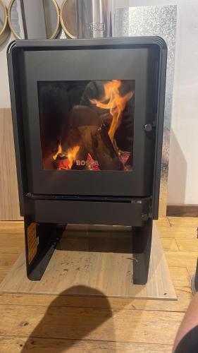 a fire in a stove in a living room at Cabaña Maitencillo frente al mar in Maitencillo