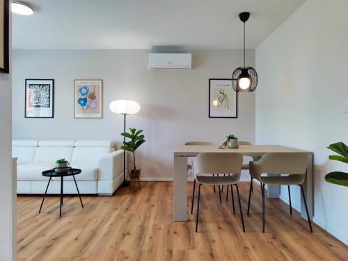 a living room with a table and chairs and a couch at Greg's House Apartments in Ljubljana