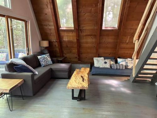 a living room with a couch and a table at The Amazing Escape in Manistee