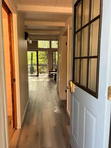 an open door to a hallway with a wooden floor at The Amazing Escape in Manistee