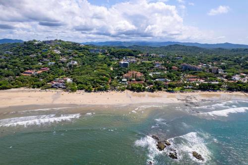 an aerial view of a beach with a town at Iguana Surf Camp in Tamarindo