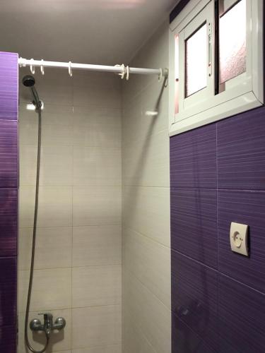 a bathroom with a shower and a window at Beachfront Bliss in Martil