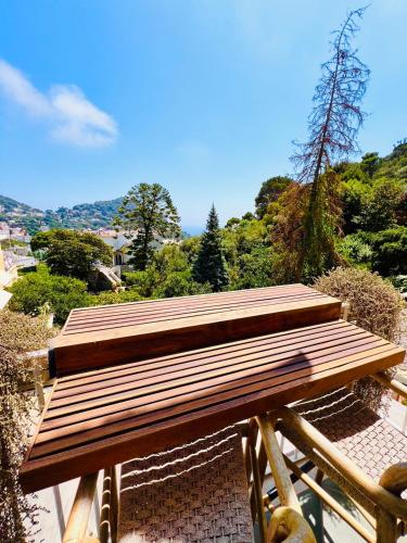 a wooden bench sitting on top of a hill at Casa Maddy in Capri
