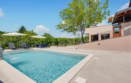 a swimming pool in the backyard of a house at 2 Bedroom Cozy Home In Kobasicari in Kobasičari