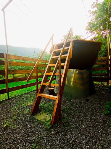 a wooden ladder next to a boat next to a fence at Guest house VL in Alaverdi