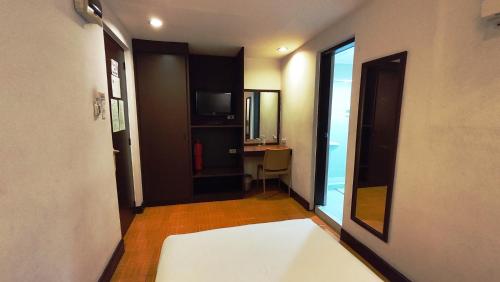 a room with a hallway with a bed and a desk at Rajah Park Hotel by Hiverooms in Cebu City