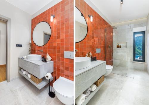 an orange tile bathroom with a sink and a toilet at Villa Horto in Livade