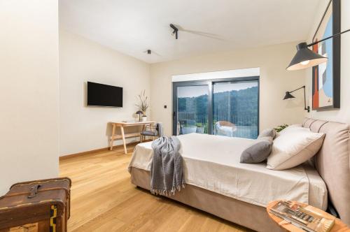 a bedroom with a bed and a sliding glass door at Villa Horto in Livade